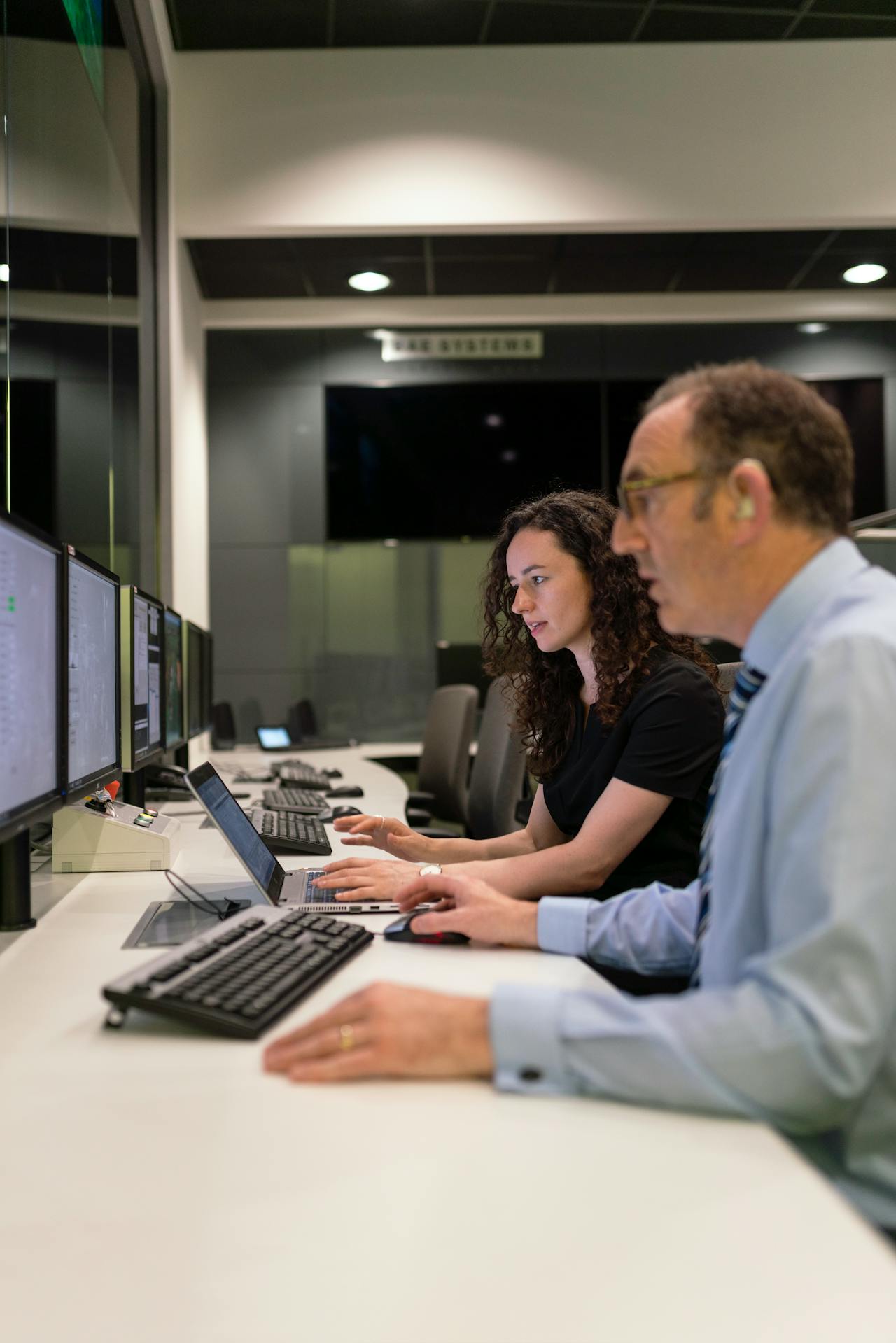 engineers sat behind computers in manufacturing office