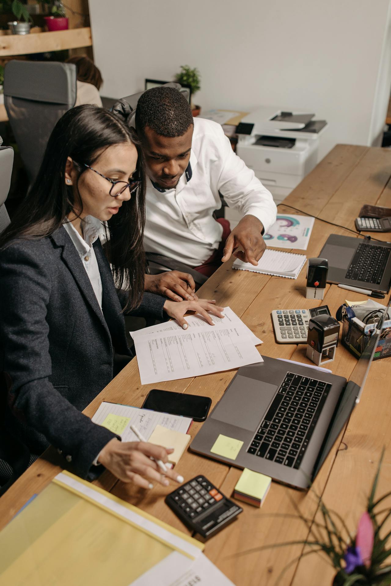 accountants working in office at desk with computer and calculator