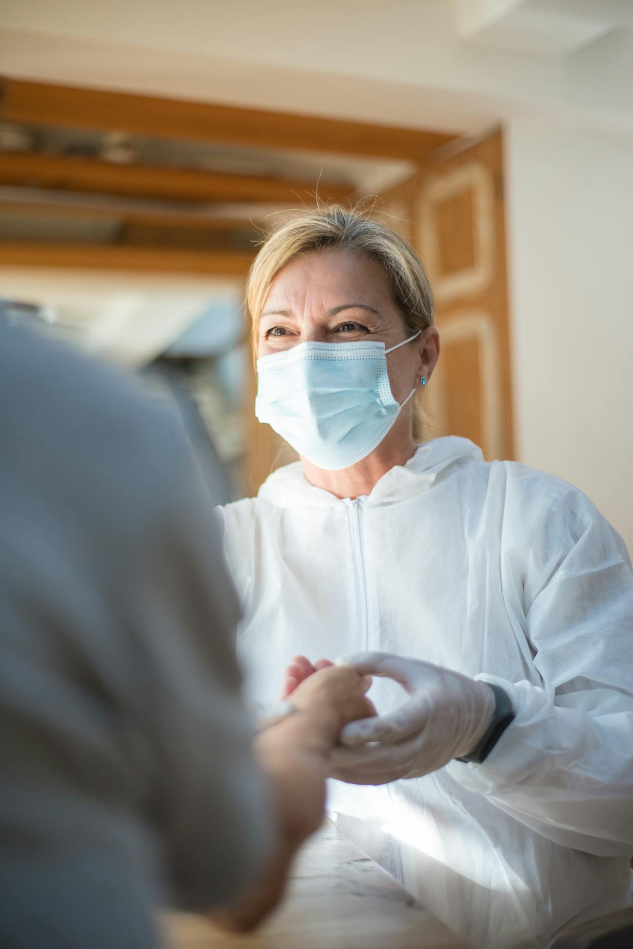 healthcare worker holding hands of patient