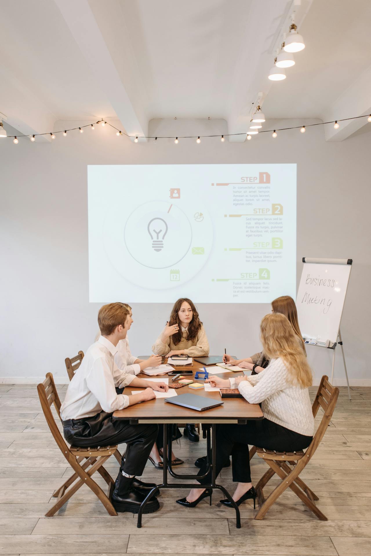 marketers sitting round a desk in marketing company office